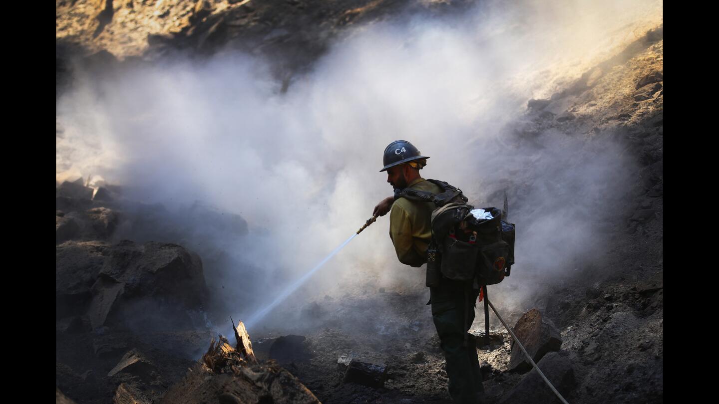Firefighter Eduardo Valle of the Valyermo Hotshots crew, works to contain the Summit fire that started burning near Big Bear.
