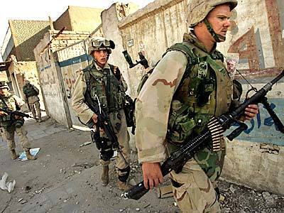 Members of Alpha Company 1st Battalion/4th Marines move through the streets of downtown Najaf, as the battle between U.S. and Sadr forces continued Tuesday. The Marines moved in closer to the city center.