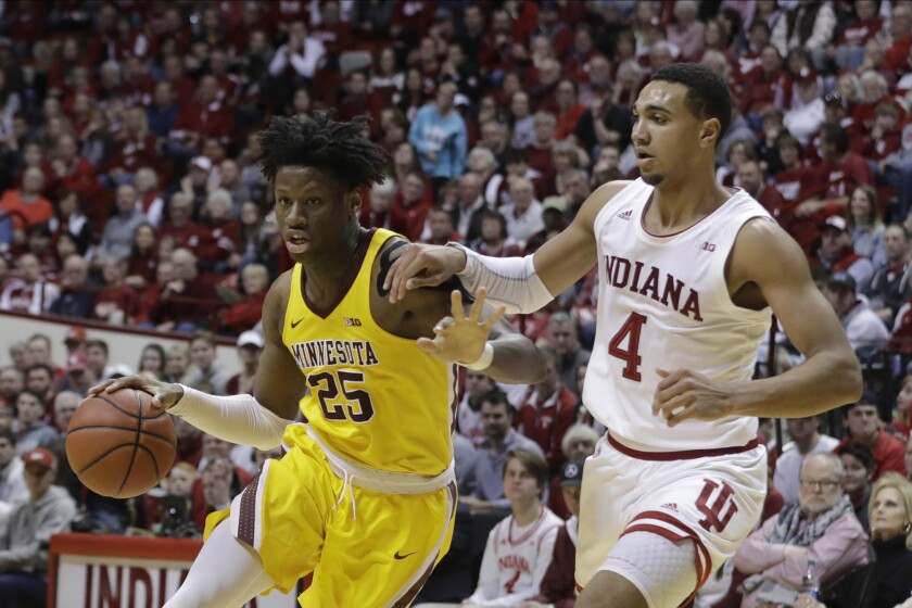 Minnesota center Daniel Oturu drives to the basket against Indiana's Trayce Jackson-Davis during a college game in March.