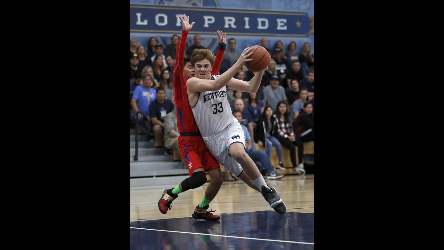 Newport Harbor High's Robbie Spooner (33) drives to the basket during the first half against Los Alamitos in a Sunset League game on Thursday.