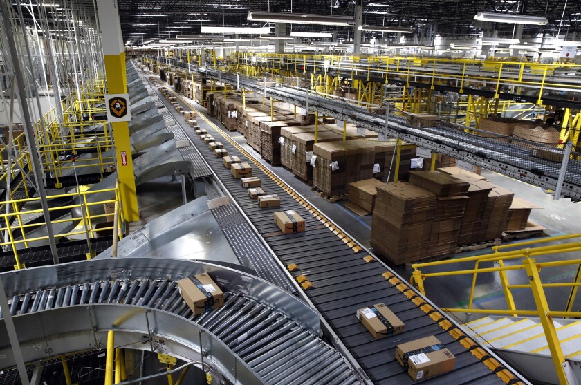 Packages ride on a conveyor system at an Amazon fulfillment center in Baltimore.