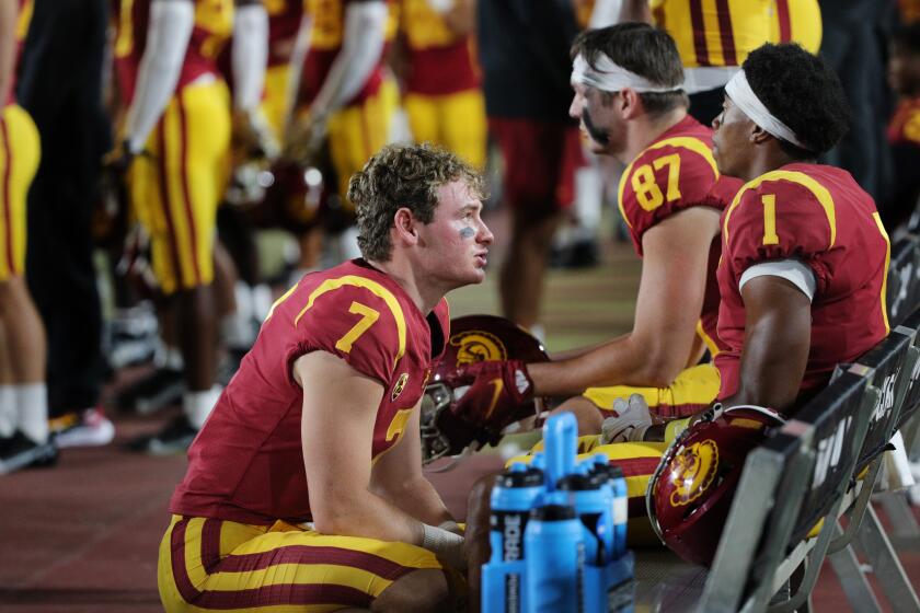 LOS ANGELES, CA - SEPTEMBER 25, 2021: USC Trojans backup quarterback Miller Moss (7) tries to console USC Trojans wide receiver Gary Bryant Jr. (1) after the Trojans 45-27 loss to Oregon State at the Coliseum on September 25, 2021 in Los Angeles, California. (Gina Ferazzi / Los Angeles Times)