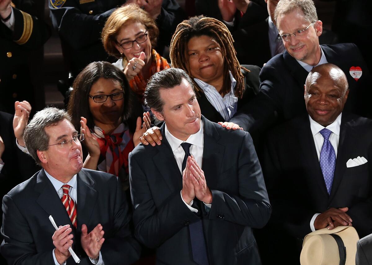 California Lt. Gov. Gavin Newsom looks on during a rally after hearing results from the U.S. Supreme Court's rulings on gay marriage at San Francisco City Hall.
