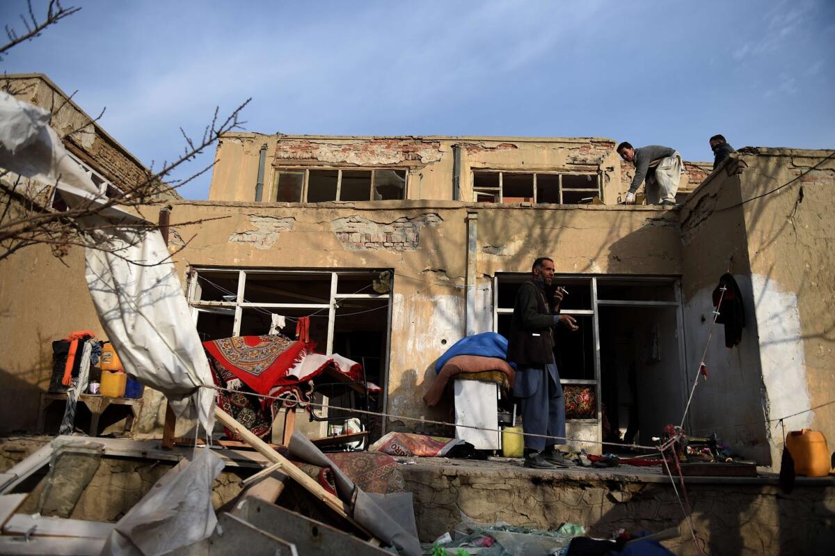 Residents salvage appliances from their homes near the site of a suicide car bomb attack at Le Jardin, a French restaurant popular with foreigners in Kabul, Afghanistan.