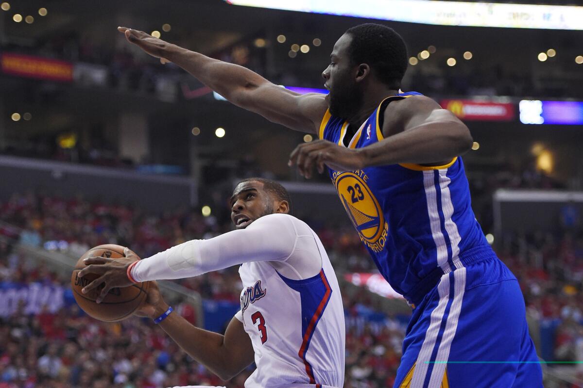 The Clippers' Chris Paul goes up for a shot Saturday against Golden State's Draymond Green.