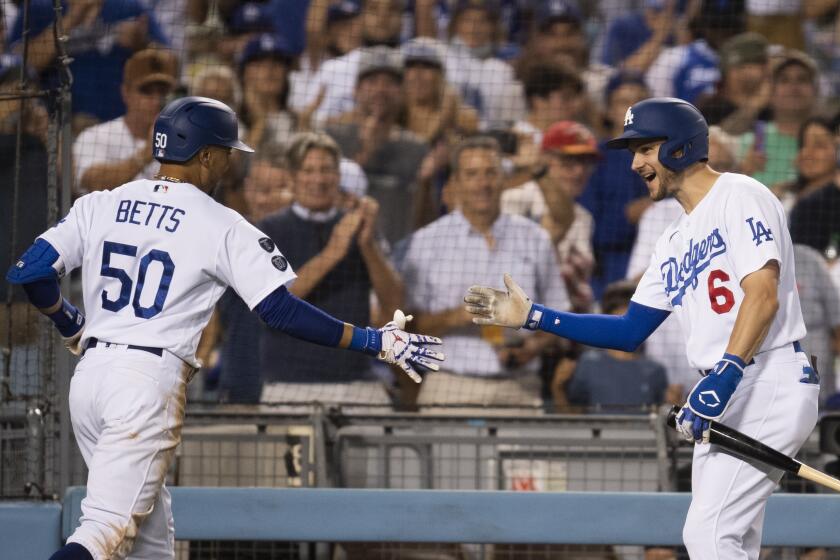Los Angeles Dodgers' Trea Turner, right, celebrates with Mookie Betts, who hit a three-run home run.