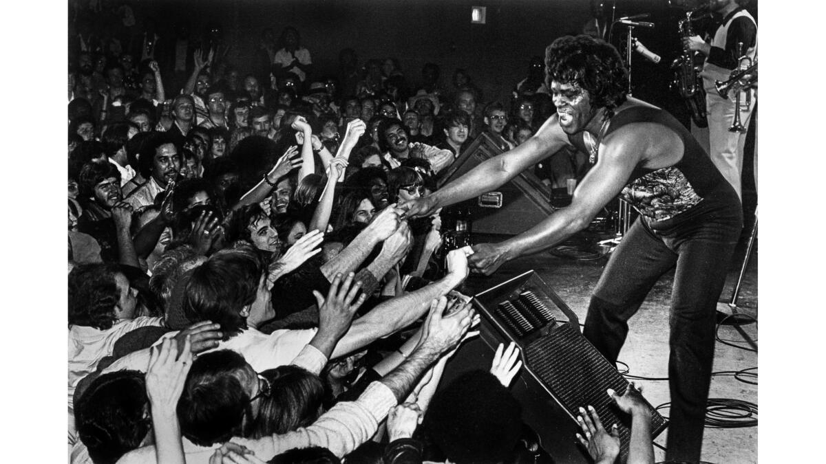Jan. 31 1982: James Brown shakes hands with enthusiastic fans at the end of the singer's triumphant show at the Country Club in Reseda.