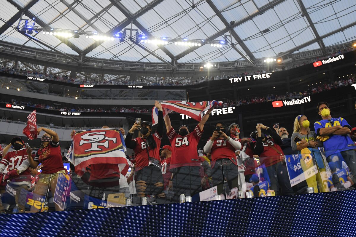 San Francisco 49ers fans celebrate after a 27-24 overtime win over the Rams on Jan. 9 at SoFi Stadium.