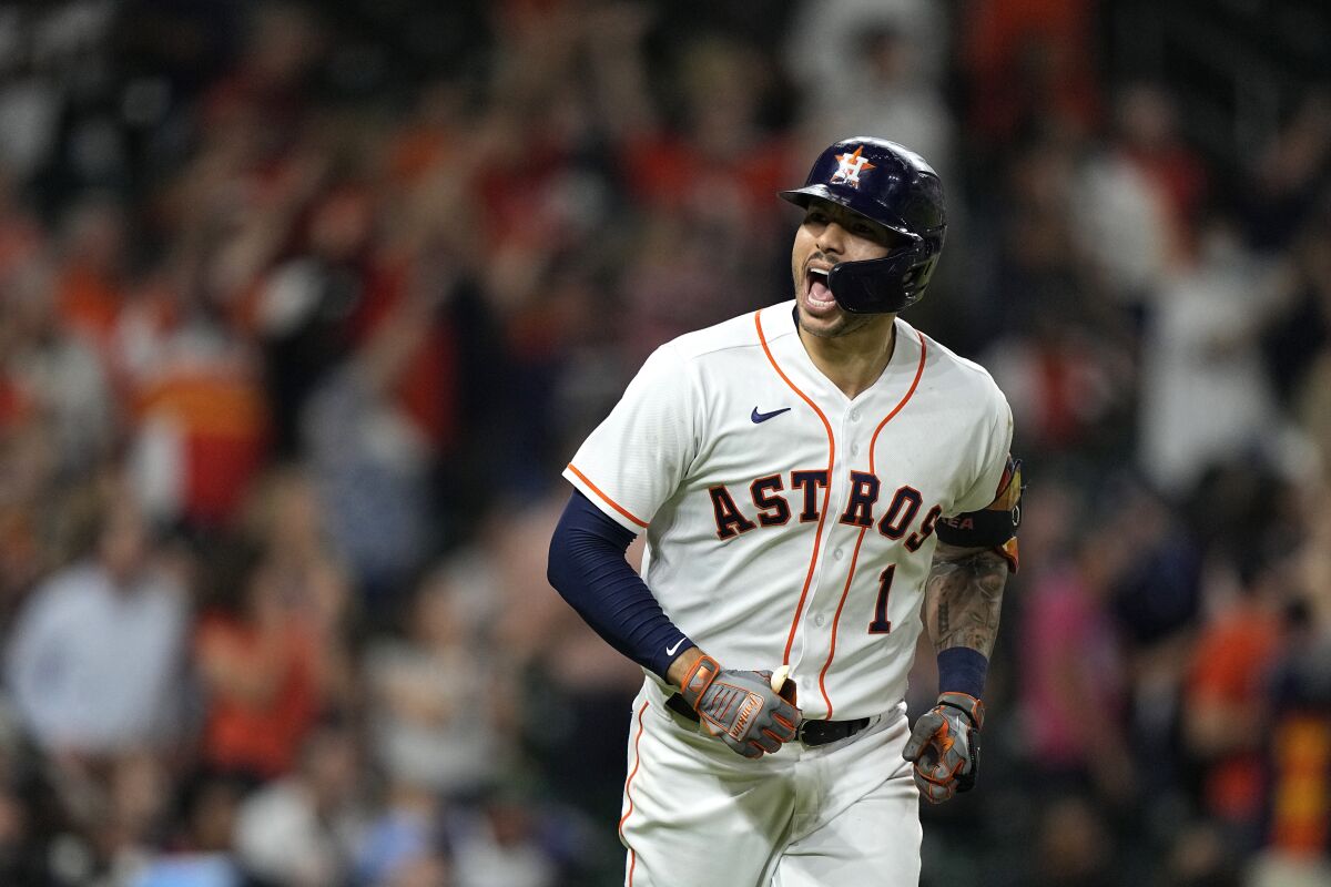 Houston Astros' Carlos Correa (1) celebrates after hitting a three-run home run against the Tampa Bay Rays during the fourth inning of a baseball game Thursday, Sept. 30, 2021, in Houston. (AP Photo/David J. Phillip)