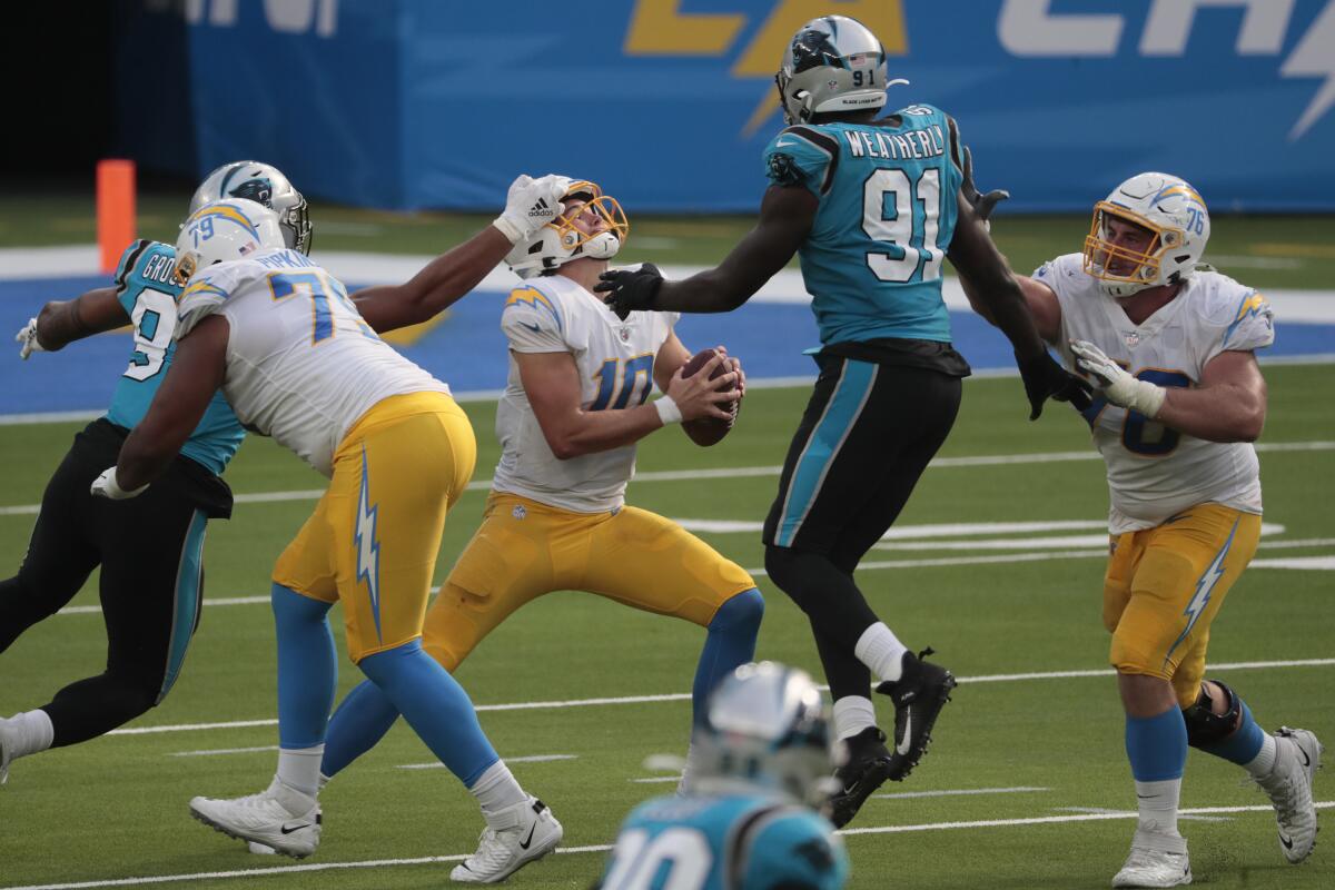 The Panthers' pass rush pressures Chargers quarterback Justin Herbert.