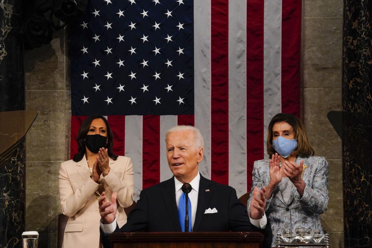 President Biden is flanked by Vice President Kamala Harris and House Speaker Nancy Pelosi.