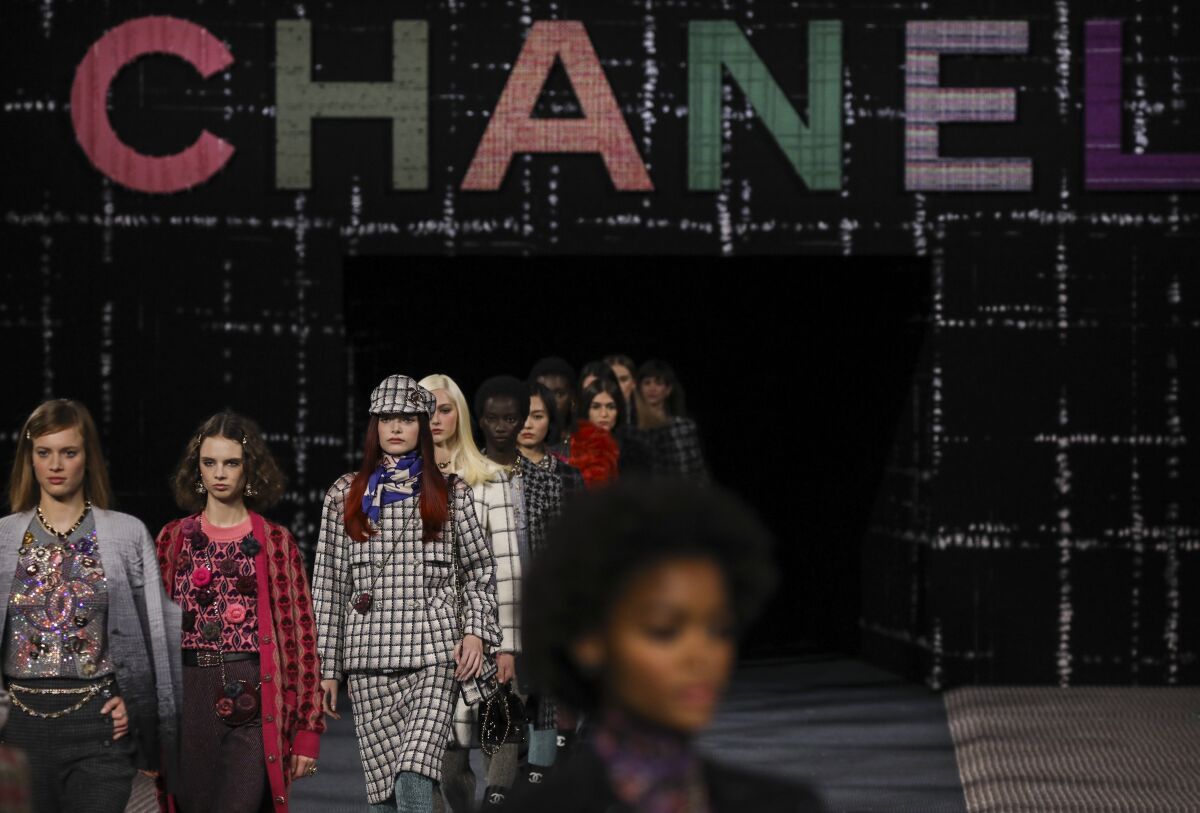 Models wear creations as part of the Chanel Ready To Wear Fall/Winter 2022-2023 fashion collection, unveiled during the Fashion Week in Paris, Tuesday, March 8, 2022. (Photo by Vianney Le Caer/Invision/AP)