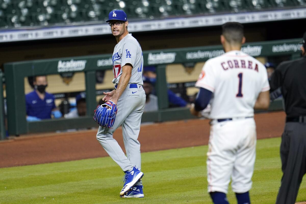 Los Angeles Dodgers relief pitcher Joe Kelly (17) yells back at Houston Astros' Carlos Correa.