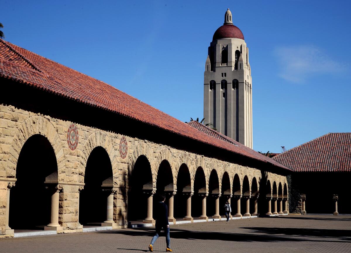 A red-roofed stone building and tower on Stanford University's campus