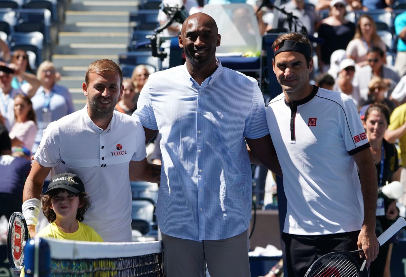 Former NBA star Kobe Bryant (C), Roger Federer (R) of Switzerland and Daniel Evans of Great Britain pose before their Round Three Men's Singles match at the 2019 U.S. Open at the USTA Billie Jean King National Tennis Center in New York on Aug. 30, 2019.