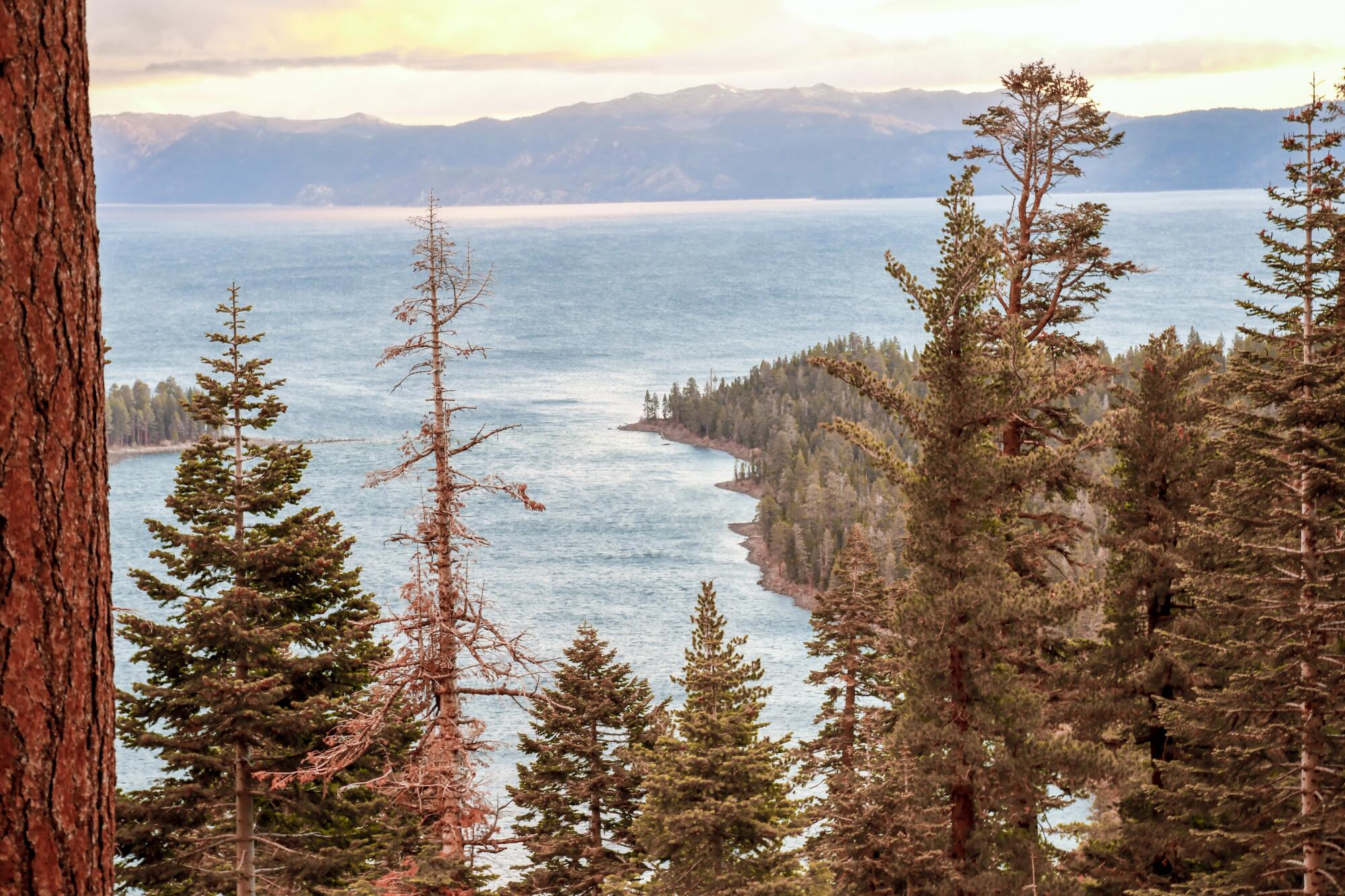 Sunrise over Lake Tahoe's Emerald Bay sometimes comes with billowing clouds and rainbows.