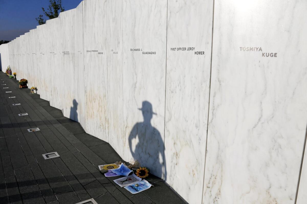 A National Park Ranger's shadow falls on the Wall of Names at sunrise before a Service of Remembrance at the Flight 93 National Memorial in Shanksville, Pa., as the nation marks the 14th anniversary of the Sept. 11 attacks.