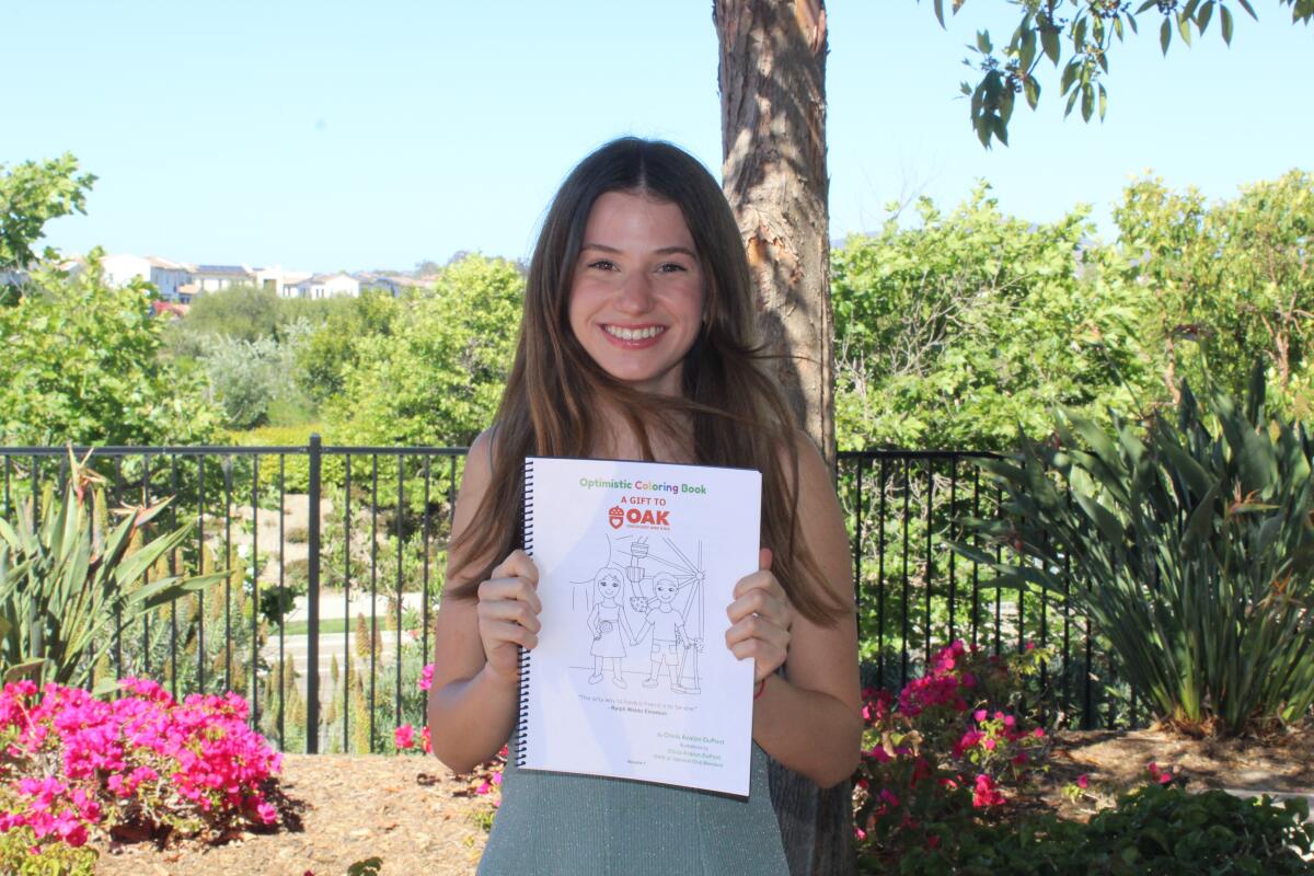 Olivia DuPont with her Optimistic Coloring Book.