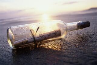 MESSAGE IN BOTTLE ON BEACH AT SUNSET - stock photo