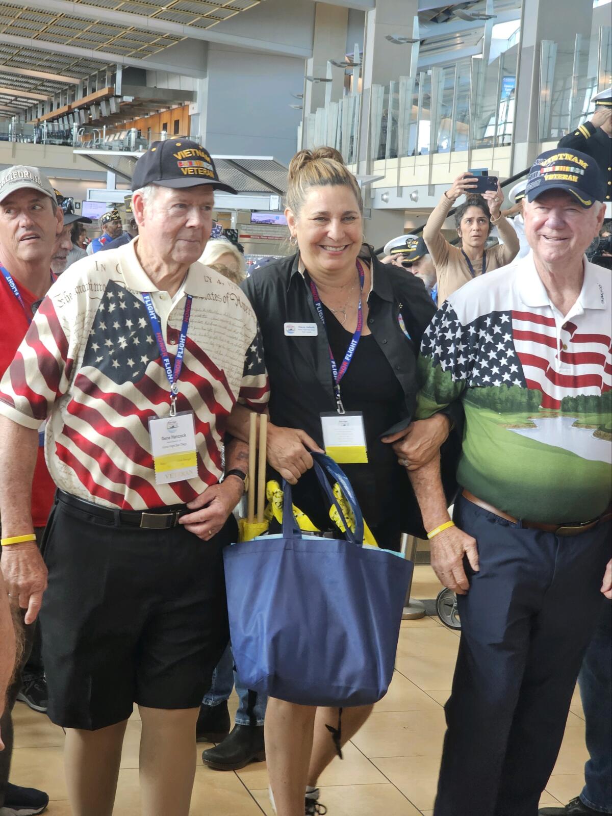 Stacey Halboth with veterans Gene Hancock and Ed Chitwood at the airport homecoming.