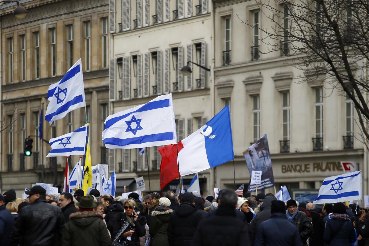 Pro-Israel demonstrators hold Israeli and French flags during a gathering in front of Israel embassy in Paris on Jan. 15, 2017.