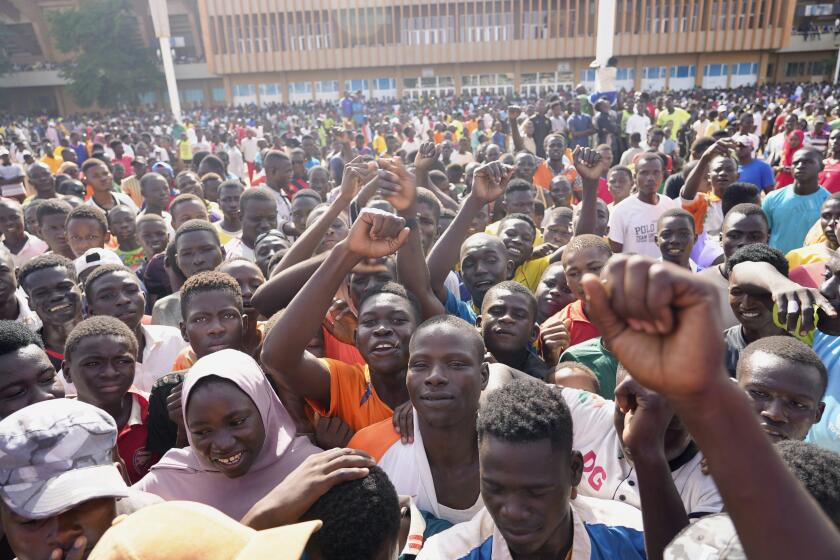 Young people gather to register to volunteer to fight for the country as part of a volunteer initiative, in Niamey, Niger, Saturday, Aug. 19, 2023. Thousands turned up as a delegation from regional nations were expected to arrive in Niger in a last-ditch diplomacy effort to reach a peaceful solution with mutinous soldiers who ousted the country's president last month. (AP Photo/Sam Mednick)