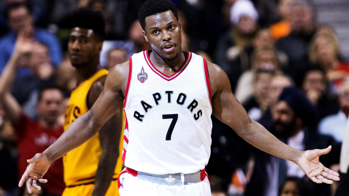 Raptors guard Kyle Lowry reacts after making a three-pointer against the Cavaliers during the second half Friday night.