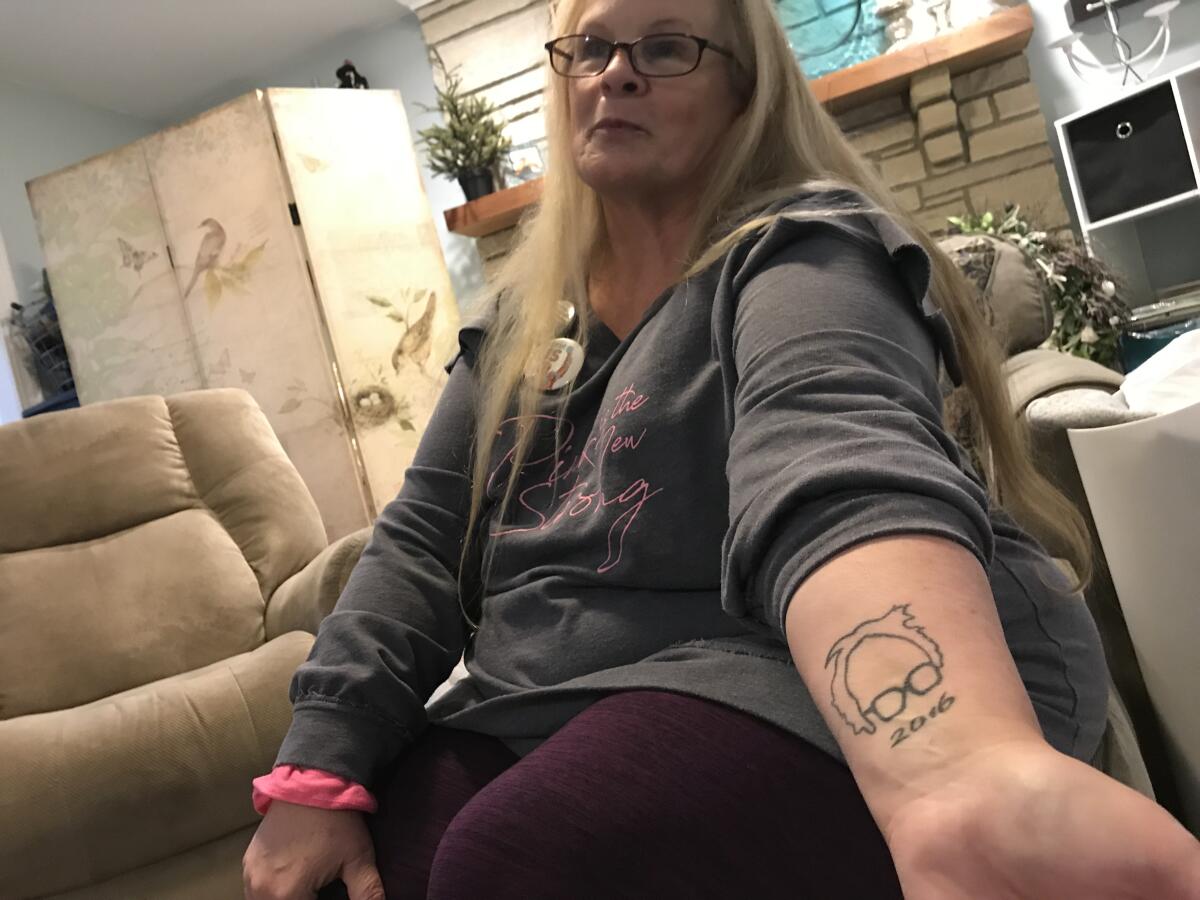 Gina Franklin, 62, of Marion, Iowa, shows off a tattoo of Sen. Bernie Sanders at a phonebanking session for his 2020 campaign.
