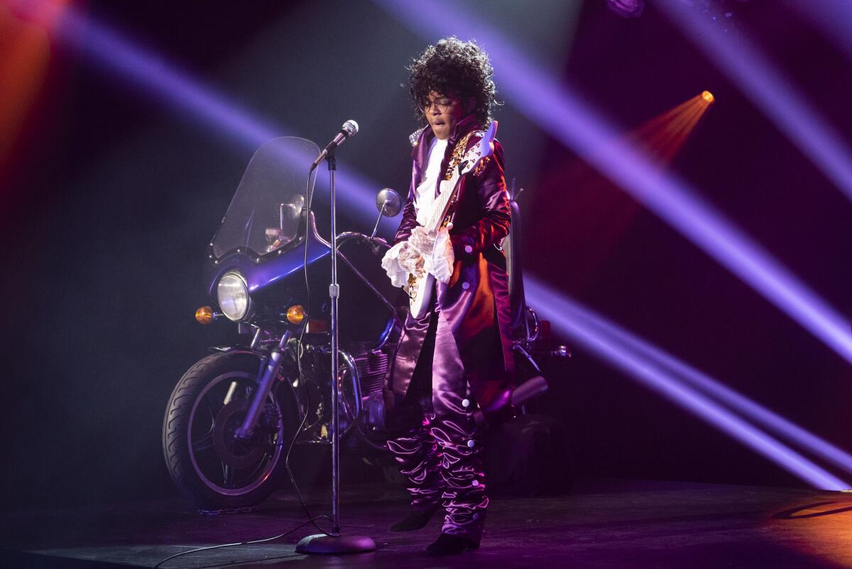 A girl dressed as Prince in his "Purple Rain" era.