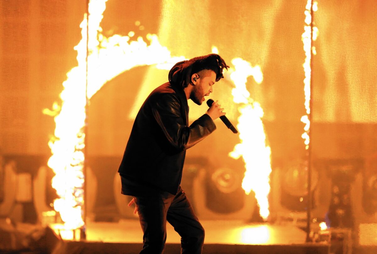 The Weeknd (Abel Tesfaye), seen performing at the American Music Awards in November, seems even more twisted on "Beauty Behind the Madness."