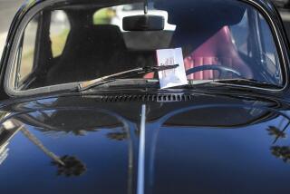 A car off Hawthorn Avenue in Hollywood is ticketed on street-sweeping day.