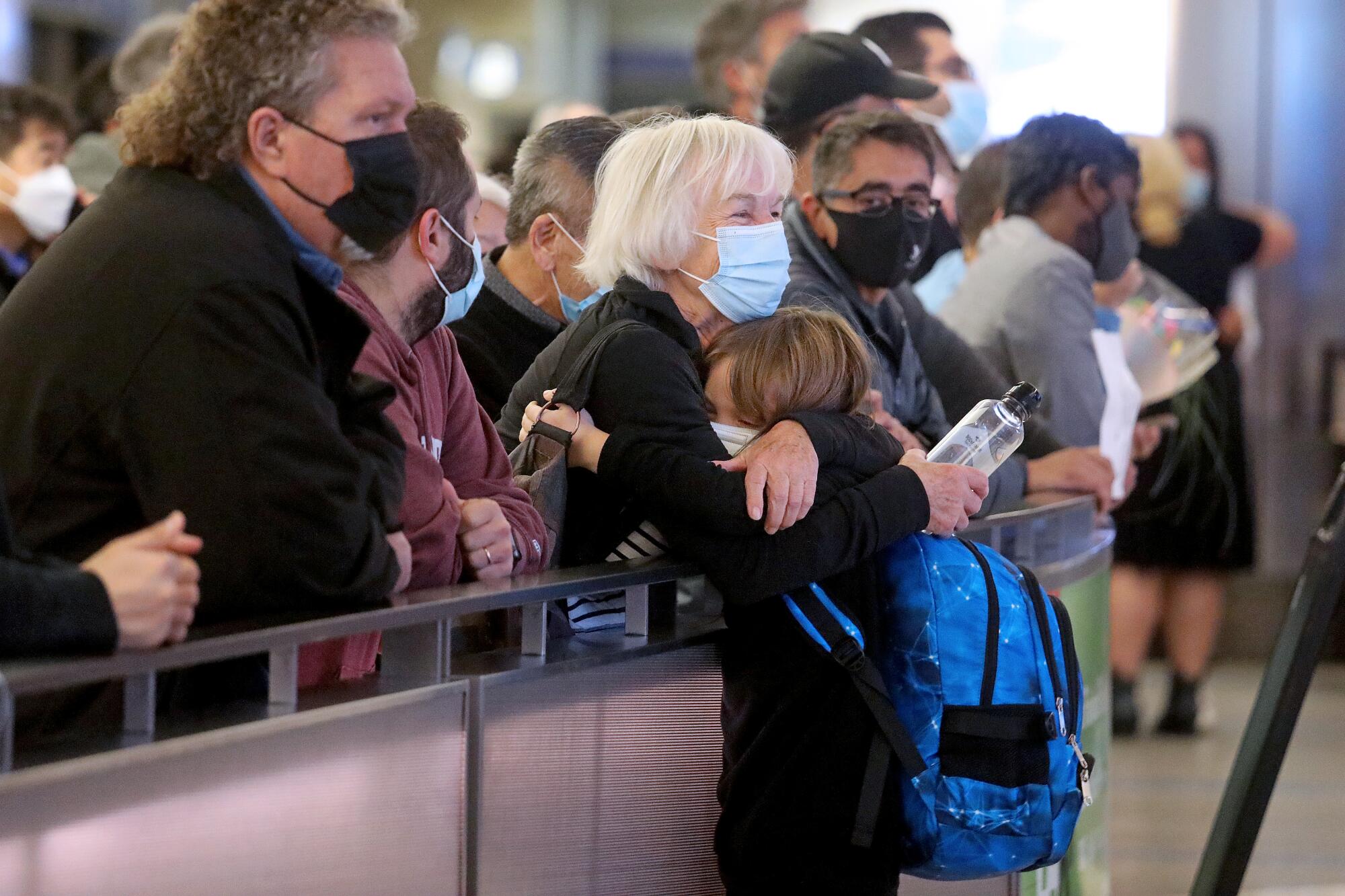 Martina Sung, left, greets her grandson Heinrich Sung, who is visiting from Europe.