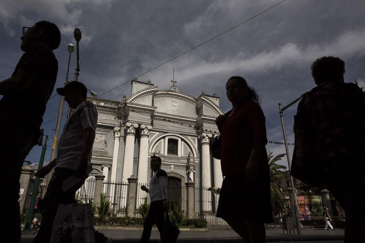 People walk Friday in the historic center of Guatemala City.