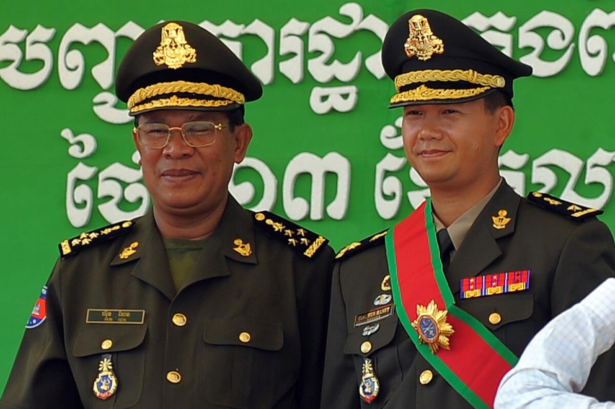 Cambodian Prime Minister Hun Sen, left, with his son, now-Gen. Hun Manet, during a ceremony at a military base in Phnom Penh in 2009.