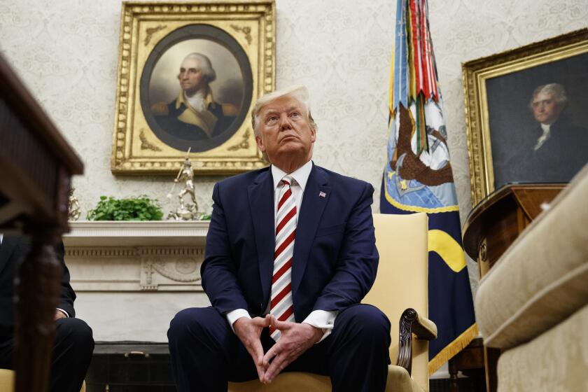 President Donald Trump pauses while speaking during a meeting with Romanian President Klaus Iohannis in the Oval Office of the White House, Tuesday, Aug. 20, 2019, in Washington. (AP Photo/Alex Brandon)