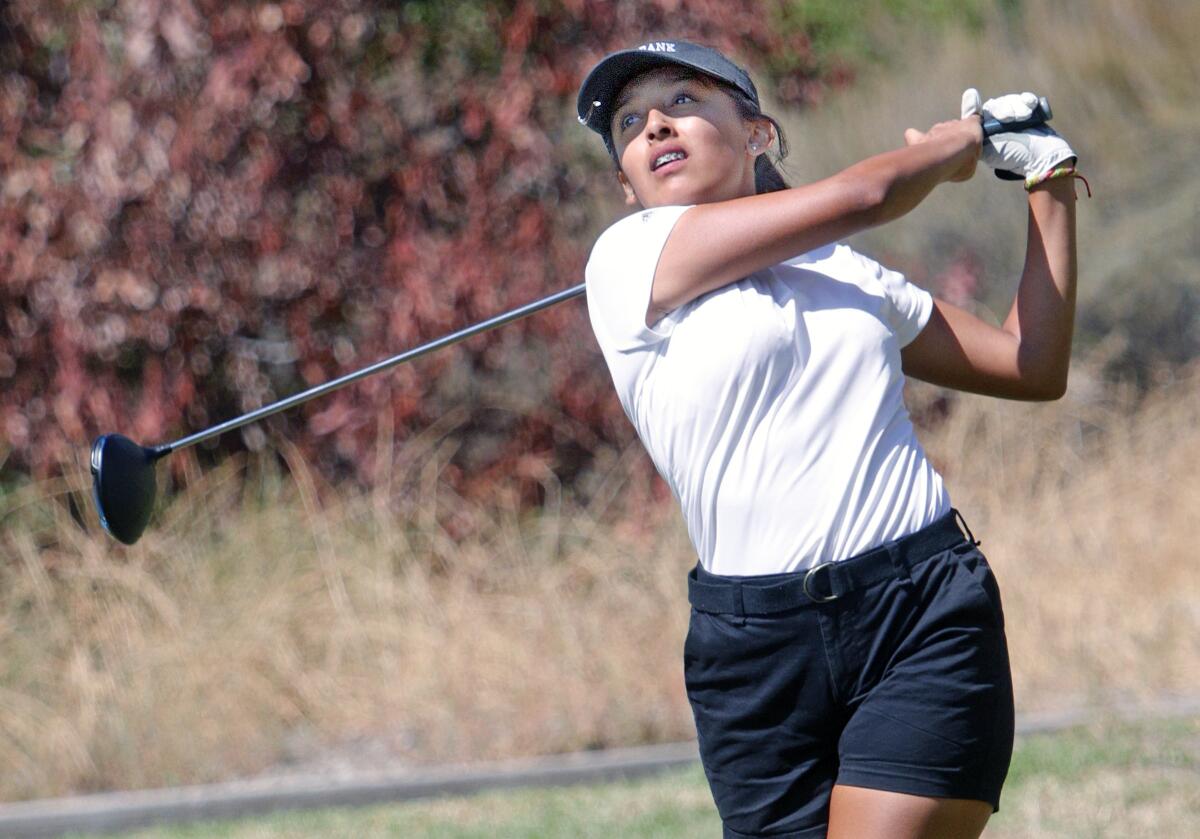 Burbank High girls' golfer Lisette Orellana tees off Thursday at the Magnolia Park Optimist Club Invitational at De Bell Golf Club. She finished first with a two-under-par 34.