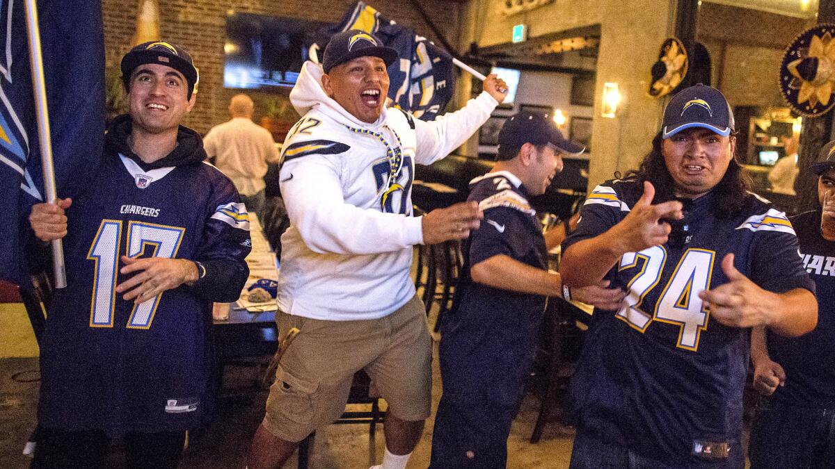 Chargers fans in Los Angeles react after hearing that the team had informed the NFL of plans to relocate from San Diego to L.A.