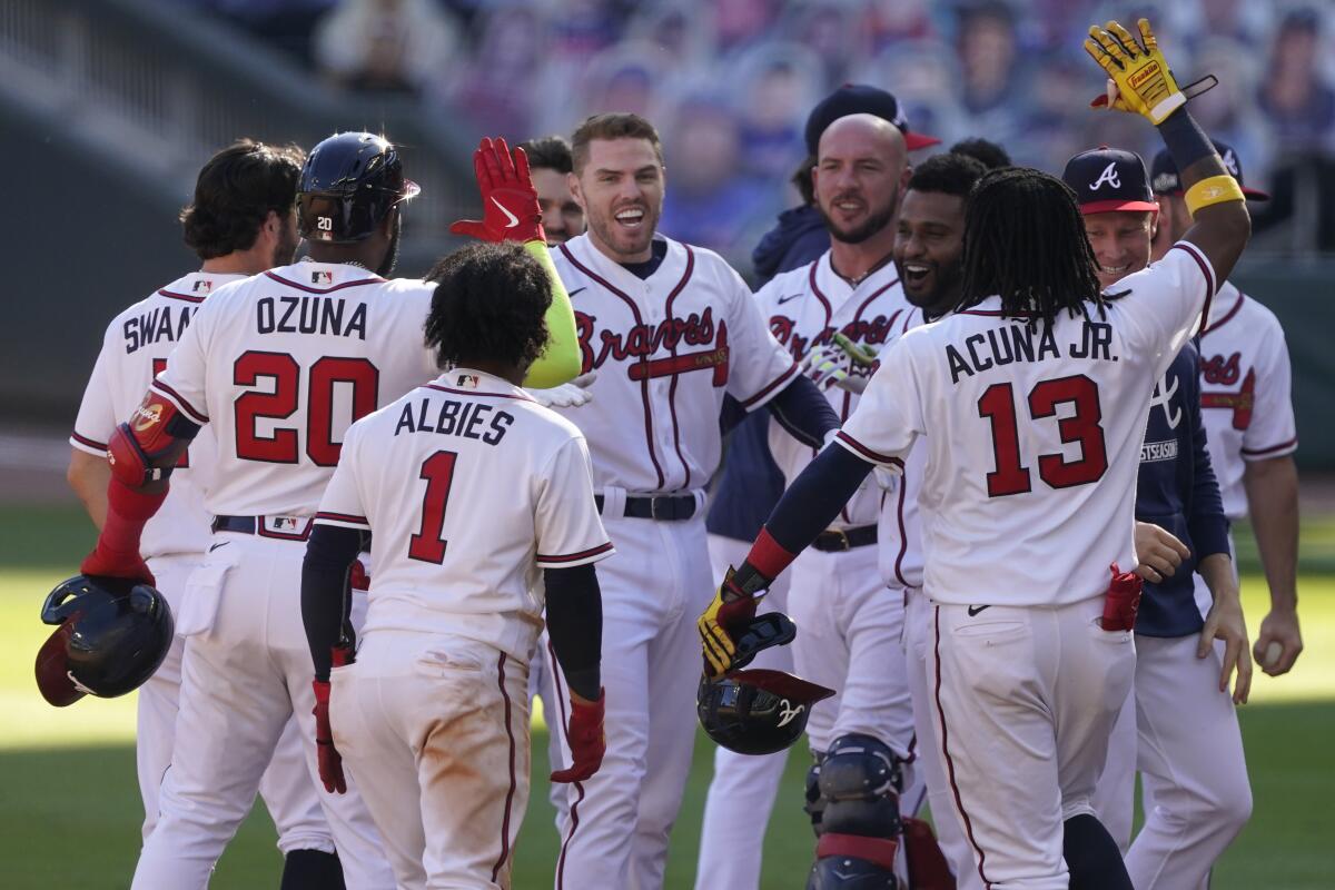 Freddie Freeman celebrates with his Atlanta Braves teammates after driving in the game-winning run Sept. 30 