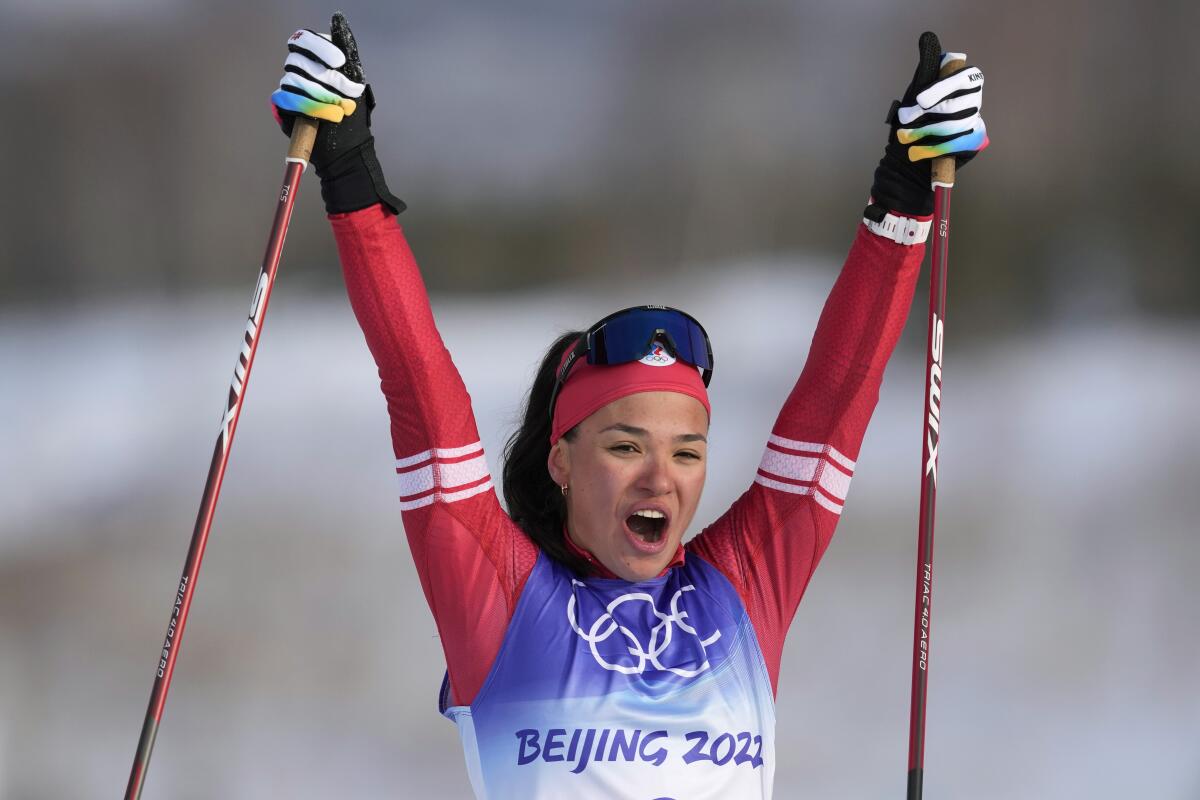 Veronika Stepanova, of the Russian Olympic Committee, celebrates after crossing the finish line.