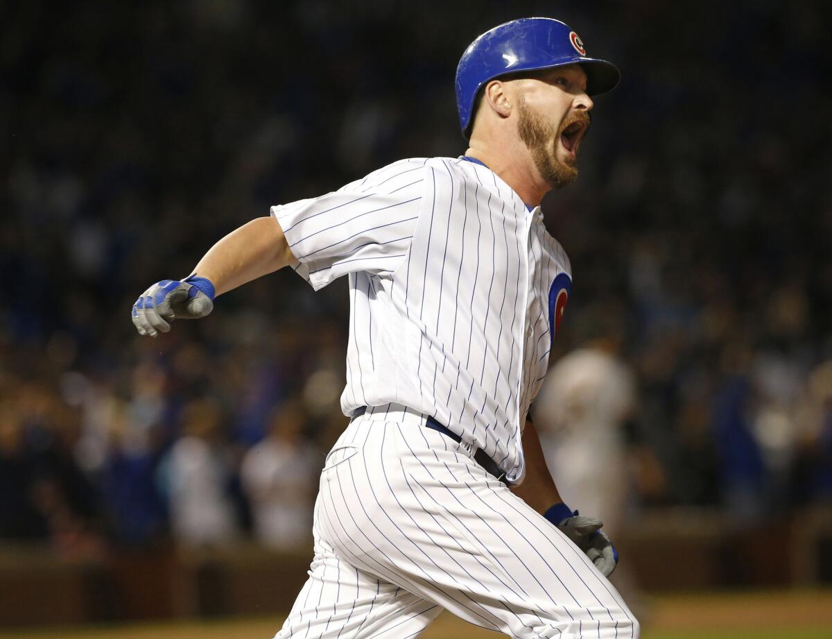 Cubs reliever Travis Wood reacts as he hits a home run in the fourth inning of Game 2 against the Giants.
