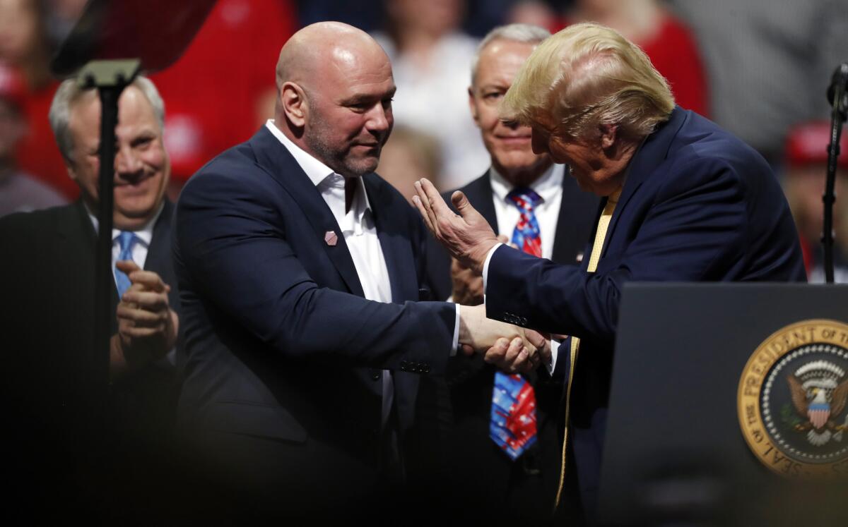 Former President Donald Trump, right, greets UFC president Dana White 