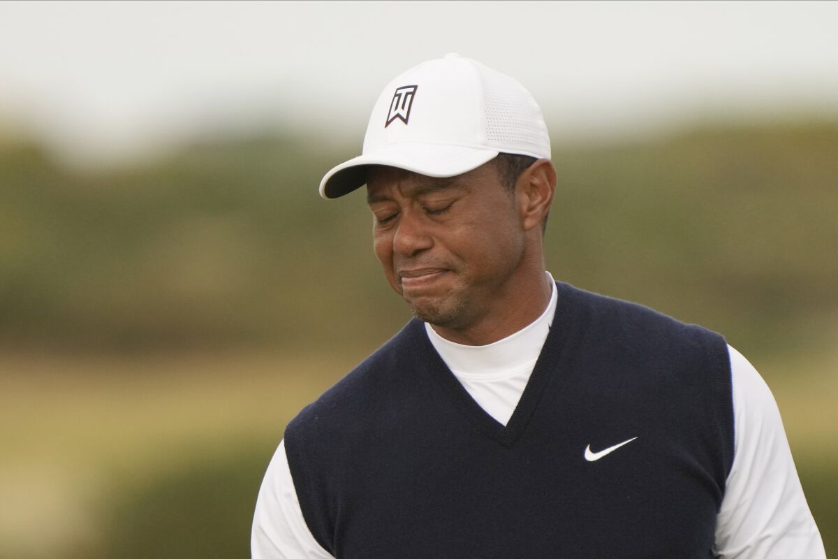 Tiger Woods of the US after putting on the 11th green during the first round of the British Open golf championship on the Old Course at St. Andrews, Scotland, Thursday July 14, 2022. The Open Championship returns to the home of golf on July 14-17, 2022, to celebrate the 150th edition of the sport's oldest championship, which dates to 1860 and was first played at St. Andrews in 1873. (AP Photo/Gerald Herbert)