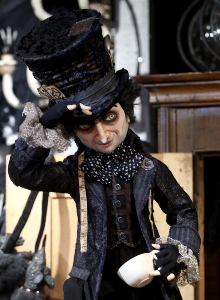 The Mad Hatter tips his hat at Roger's Gardens' "Malice in Wonderland" Halloween boutique in Corona del Mar.