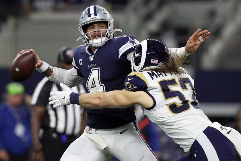 ARLINGTON, TEXAS - DECEMBER 15: Dak Prescott #4 of the Dallas Cowboys is hit by Clay Matthews #52 of the Los Angeles Rams in the second quarter at AT&T Stadium on December 15, 2019 in Arlington, Texas. (Photo by Tom Pennington/Getty Images)