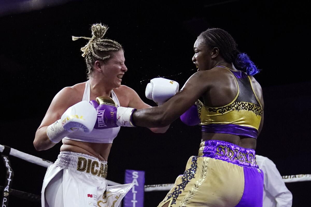 Marie-Eve Dicaire, left, and Claressa Shields face off during the eighth round of a boxing bout for the women's super welterweight title Friday, March 5, 2021, in Flint, Mich. (AP Photo/Carlos Osorio)