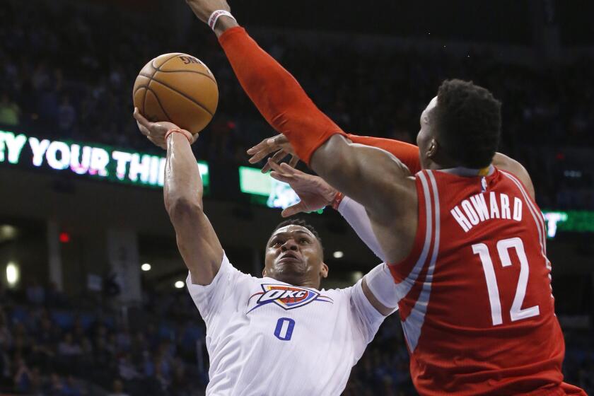 Thunder guard Russell Westbrook (0) shoots over Rockets center Dwight Howard (12) during the fourth quarter of a game on March 22.