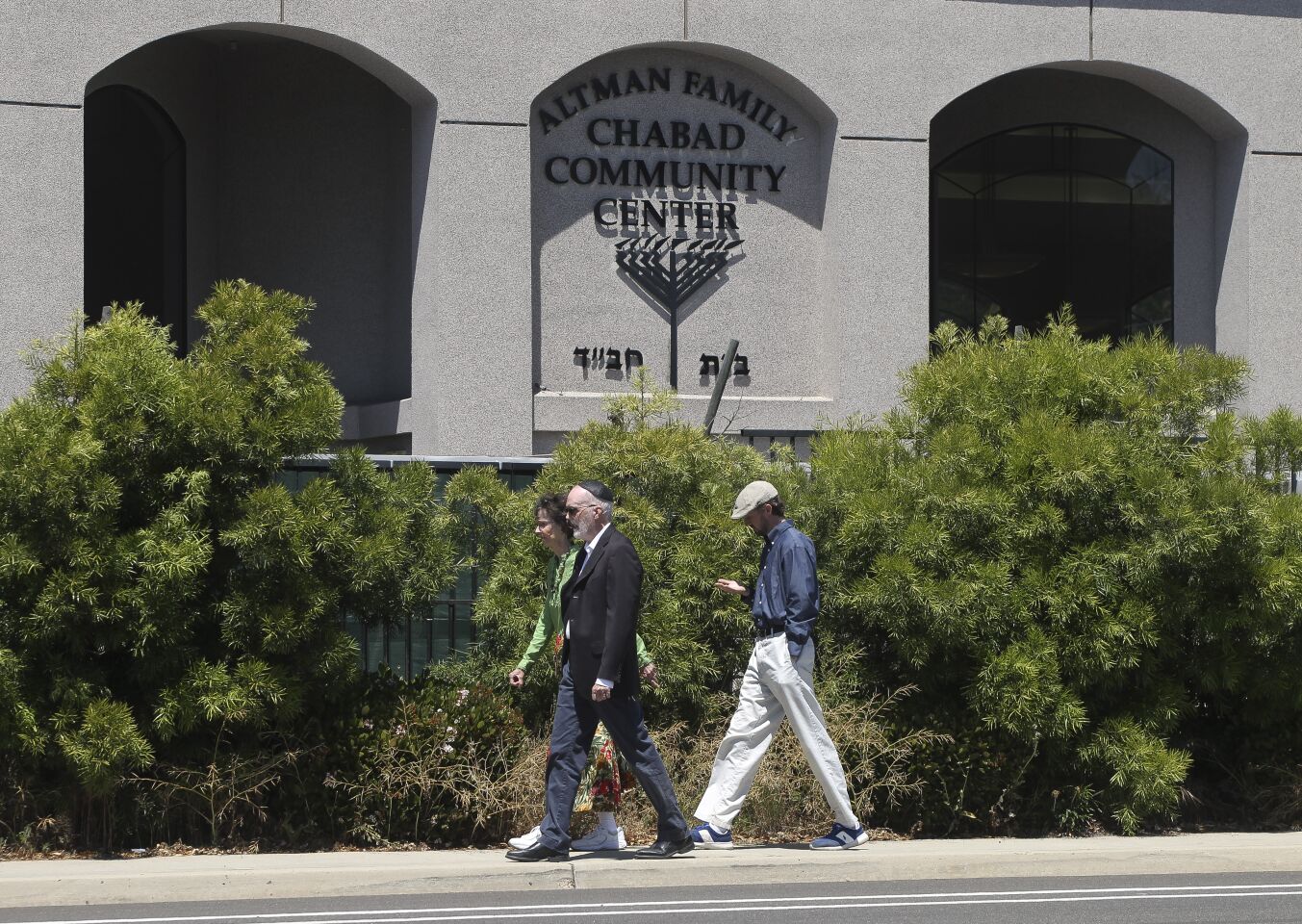 Two men and woman, who appeared to have come out of the the Altman Family Chabad Community Center, walk in front of the community center where a man with a gun shot multiple people inside, killing one, in Poway on Saturday, April 27, 2019 in Poway, California.