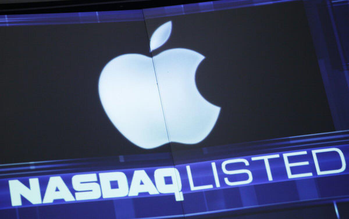 The Apple logo is shown on a Nasdaq stock ticker in New York.