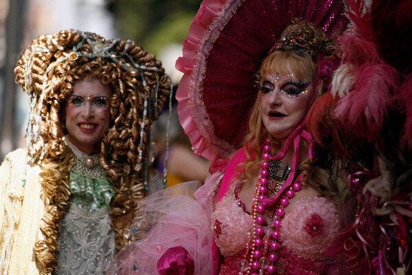 Mardi Gras revelers walk along Royal Street on Mardi Gras.