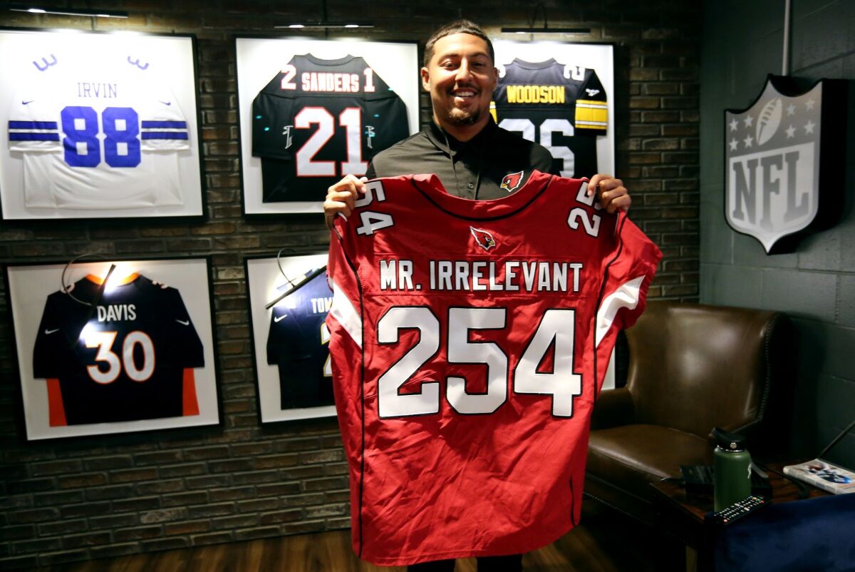 Caleb Wilson shows off his Mr. Irrelevant No. 254 jersey before being interviewed at NFL Network in Culver City on Tuesday. The Arizona Cardinals made Wilson the dead-last pick in the 2019 NFL Draft.